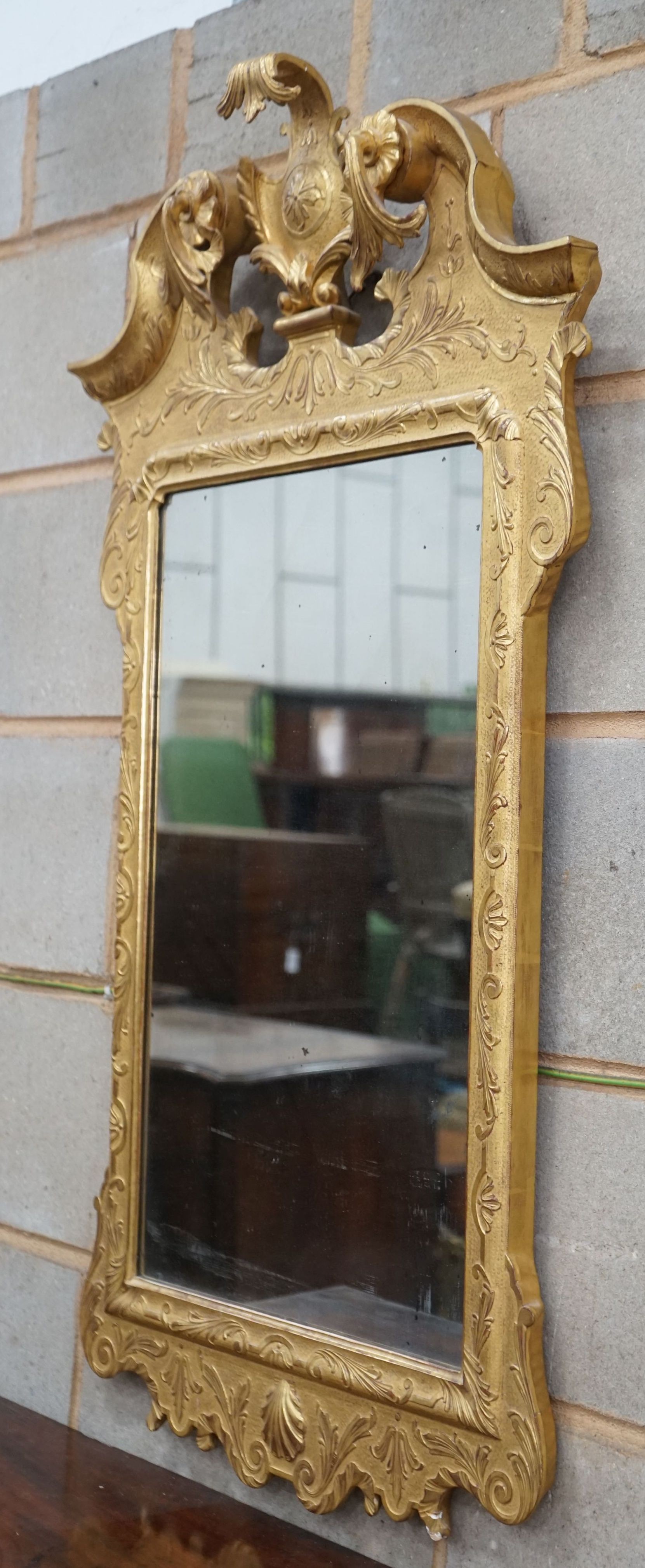 A pair of George II style carved giltwood wall mirrors, with scroll pediments, width 58cm, height 106cm